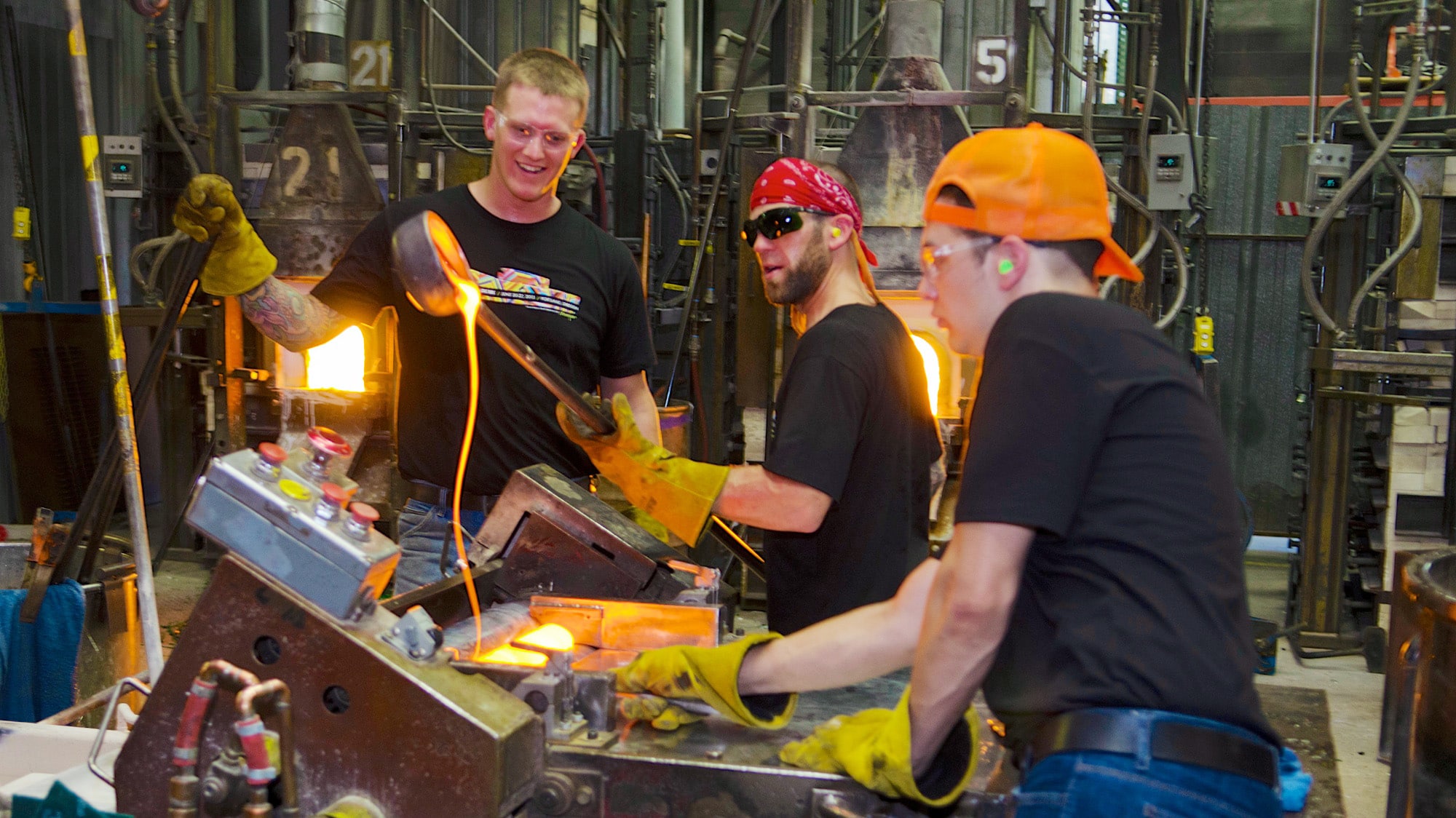 Bullseye Glass employees casting glass in the factory.