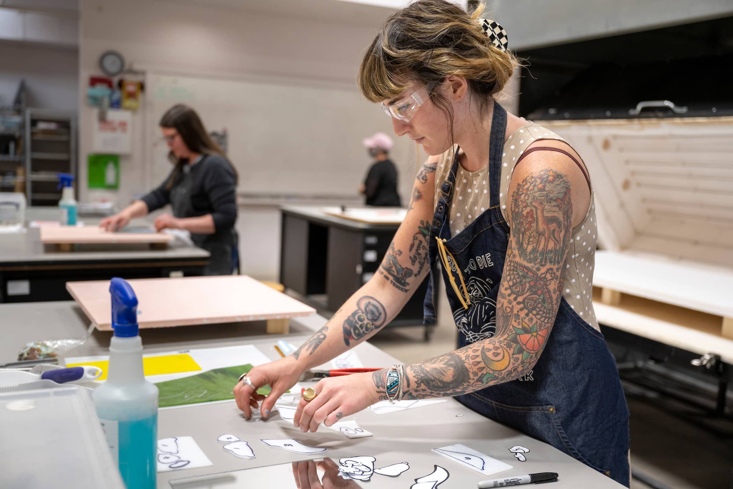 A woman working with glass in a Bullseye Glass Resource Center