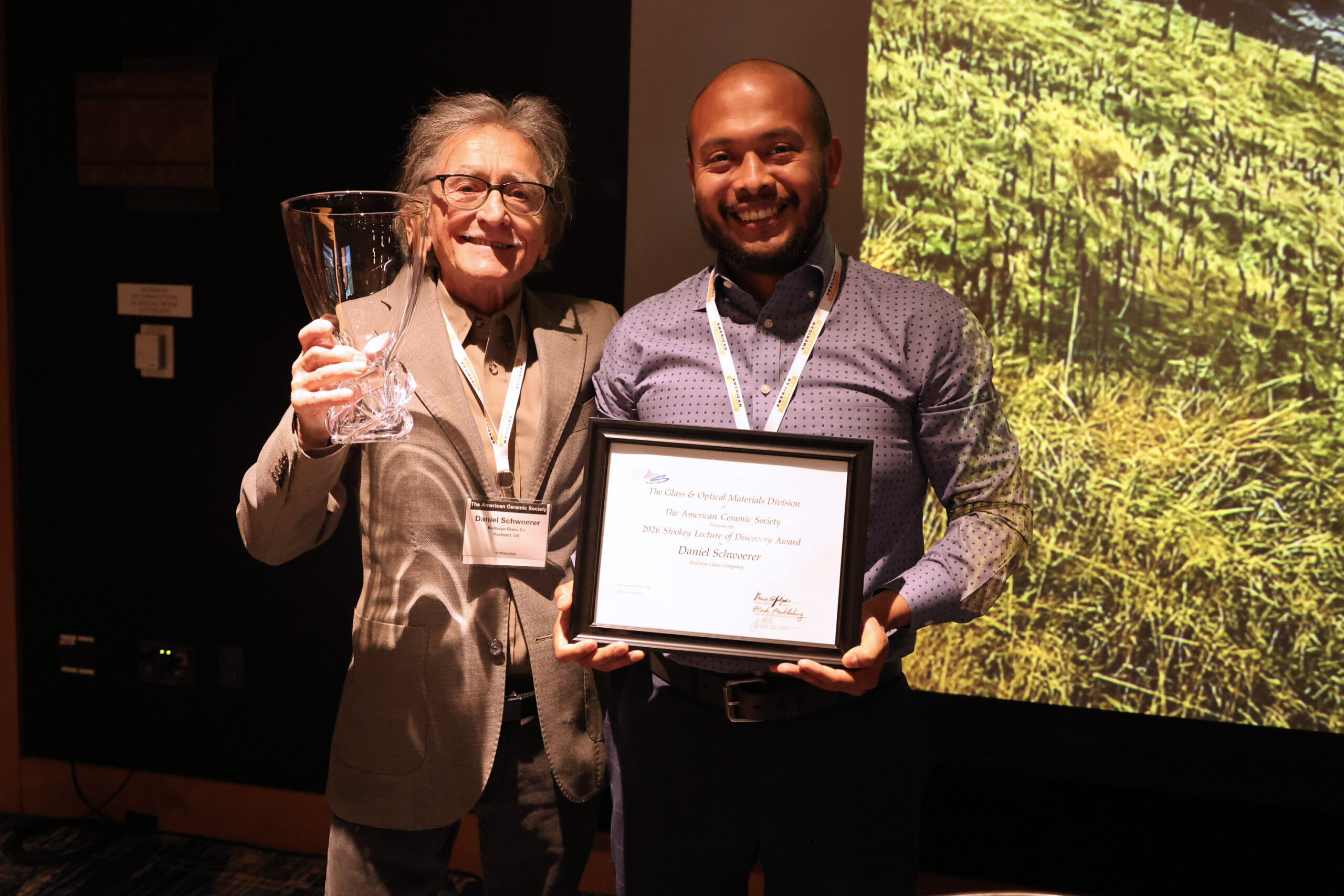 Bullseye Glass CEO Dan Schwoerer being presented the Stookey Award by Jose Marcial