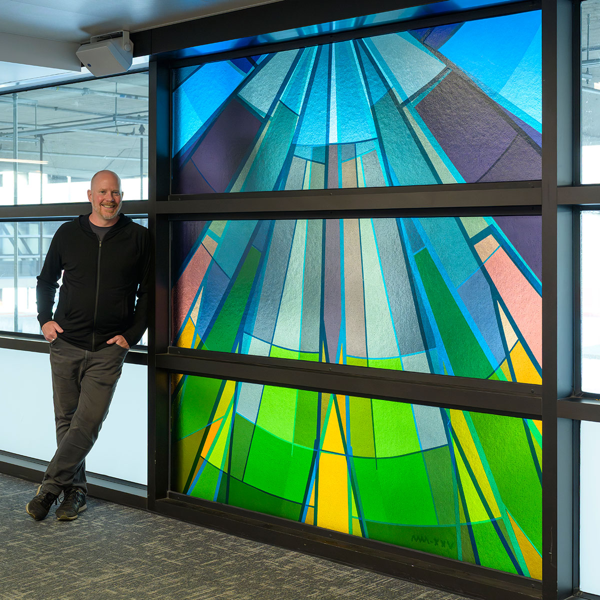 Artist Morgan Madison with one of his large-scale artworks at SeaTac airport in Seattle, Washington