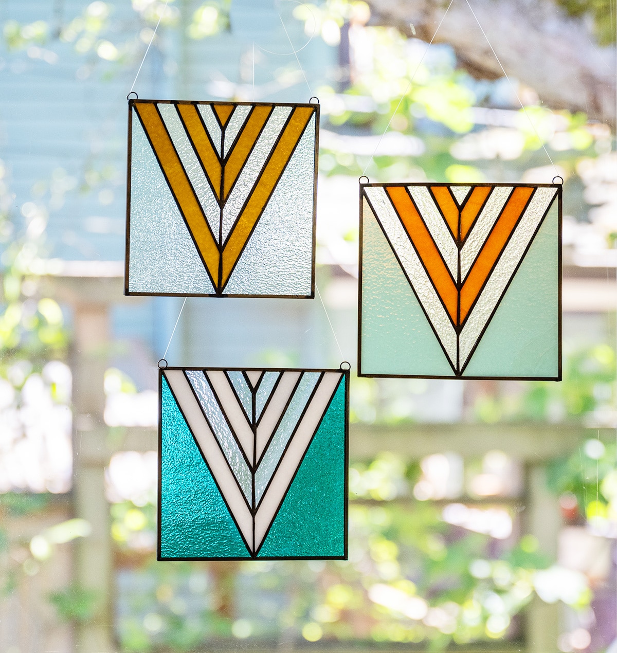 stained glass pendants in a window